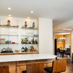 bar with seating and glass wall shelves