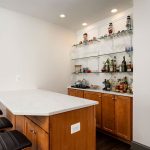 bar with seating and glass wall shelves