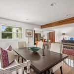 New dining area now open to kitchen and living room. Wood beams create rustic feel. first floor of home